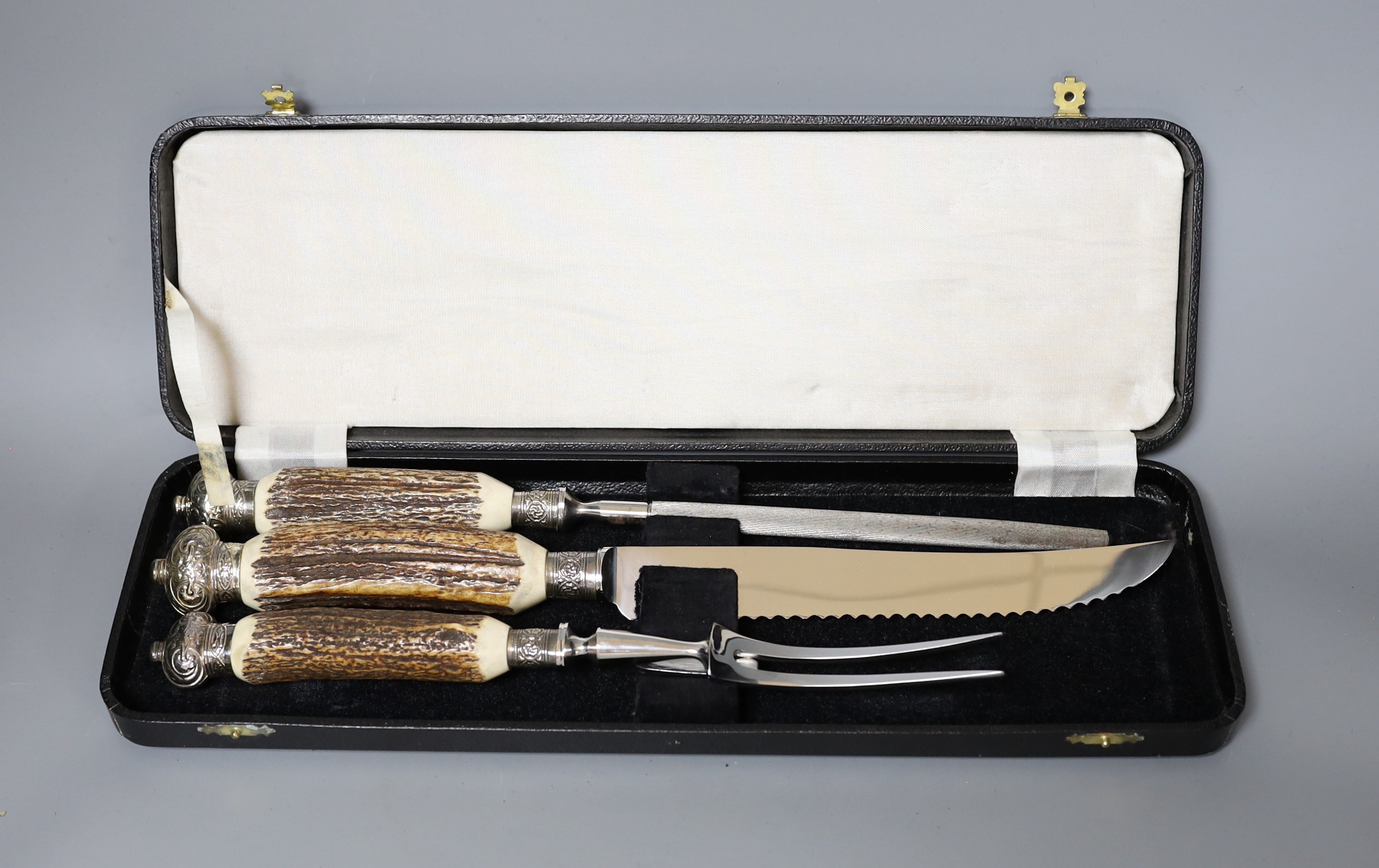 A Greenwood and Sons stag antler handled carving set, in original box